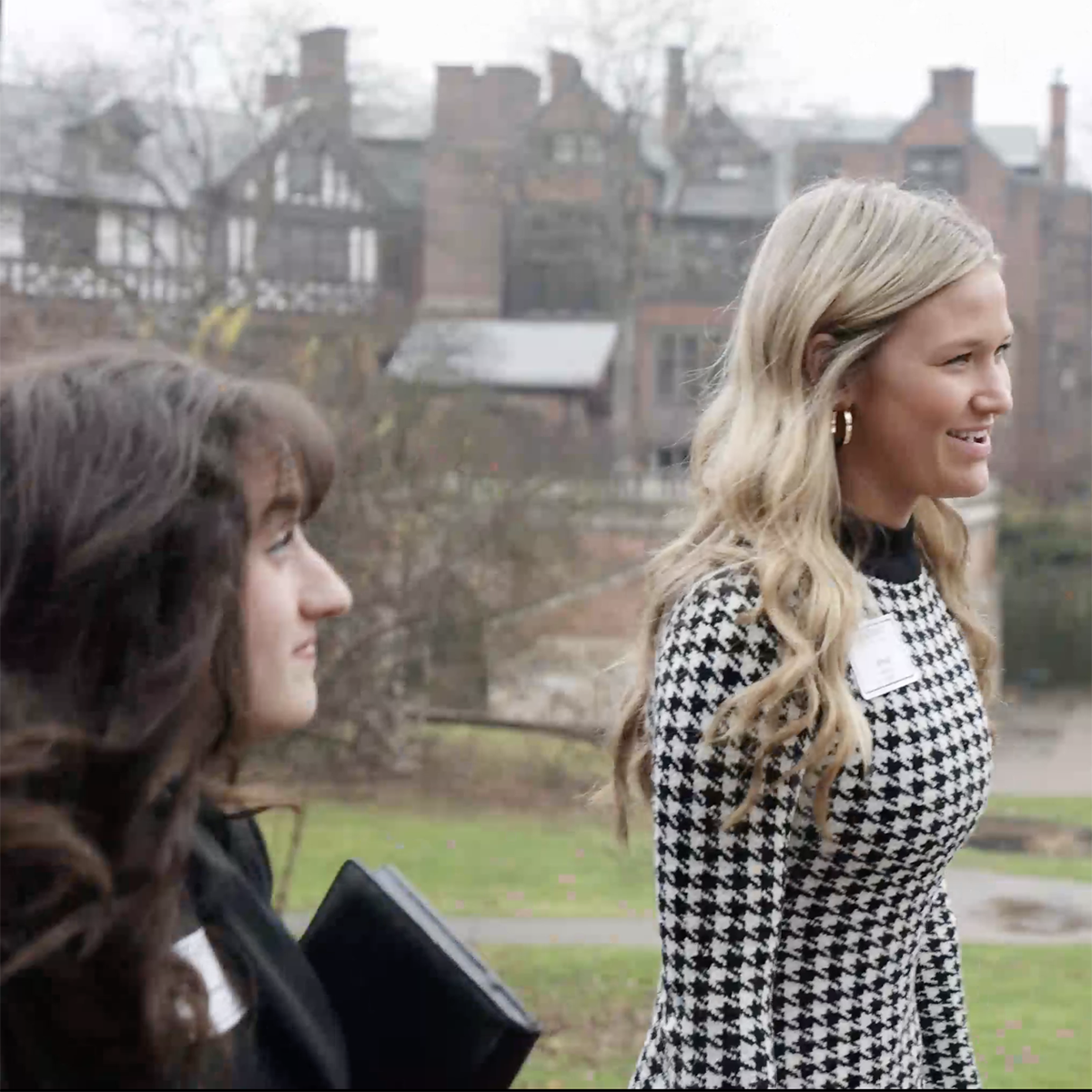 Photo of two young women in professional clothing walking on Shadyside Campus